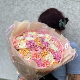 Різнокольорові діантуси – букет із 45 квітів у рожевому, білому та персиковому відтінках у бежевій обгортці з рожевою стрічкою