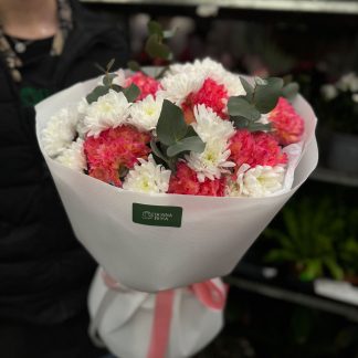 Мікс хризантеми з діантусами – букет із 9 хризантем, 9 діантусів і 2 гілок евкаліпта в прозорій упаковці з рожевим декором.